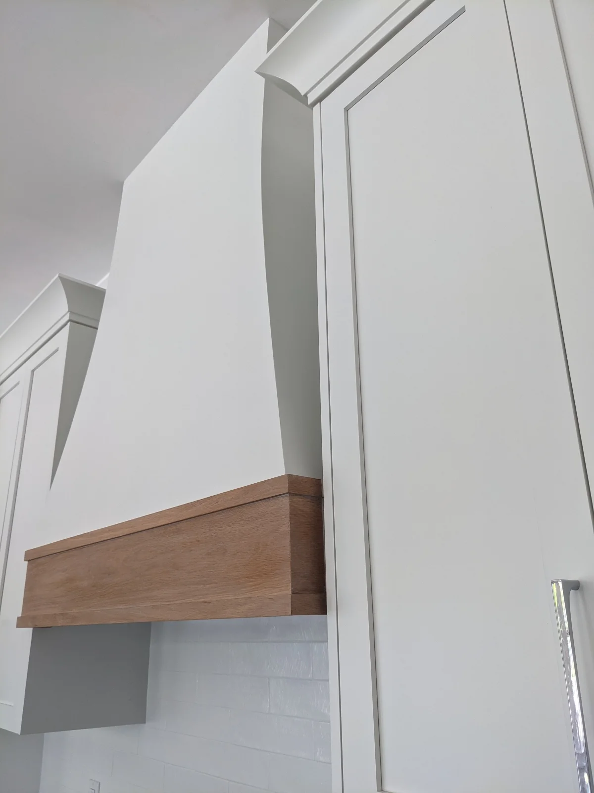 Oak accent on a custom kitchen hood